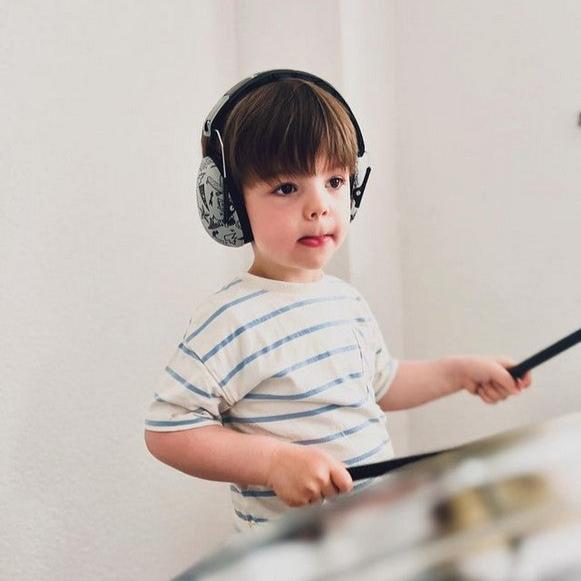 Child wearing Banz Kids Earmuffs in the Graffiti pattern 