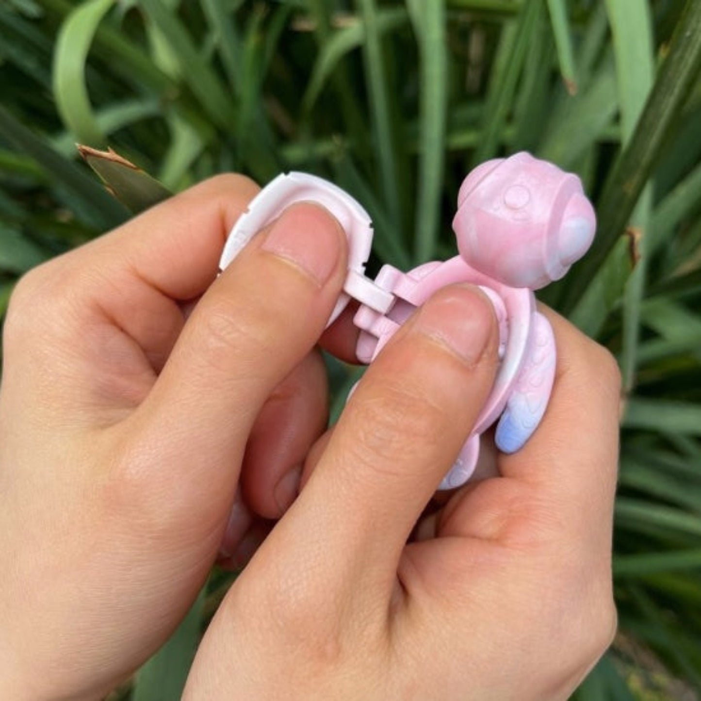 Person using an open Calm Buddi Turtle anxiety-relief fidget toy in Cloud