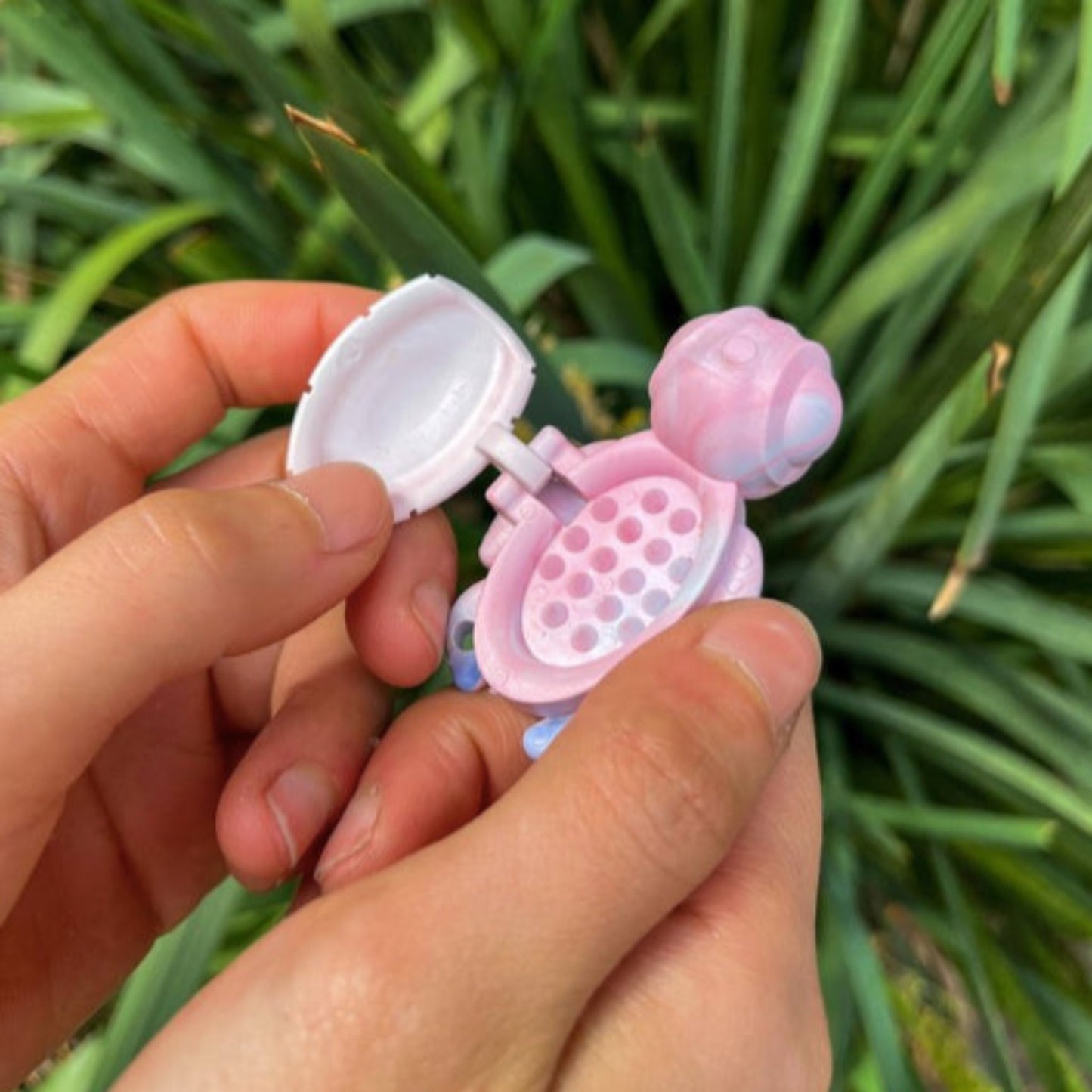 Person using an open Calm Buddi Turtle calming fidget toy in Cloud