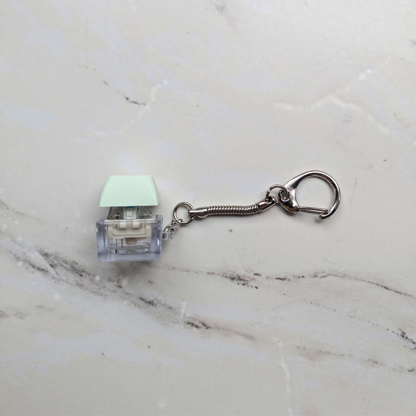 Side view of a Keyboard Fidget Clicky Keychain in Light Green