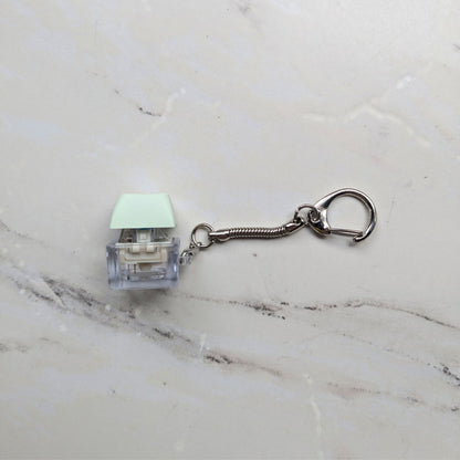 Side view of a Keyboard Fidget Clicky Keychain in Light Green