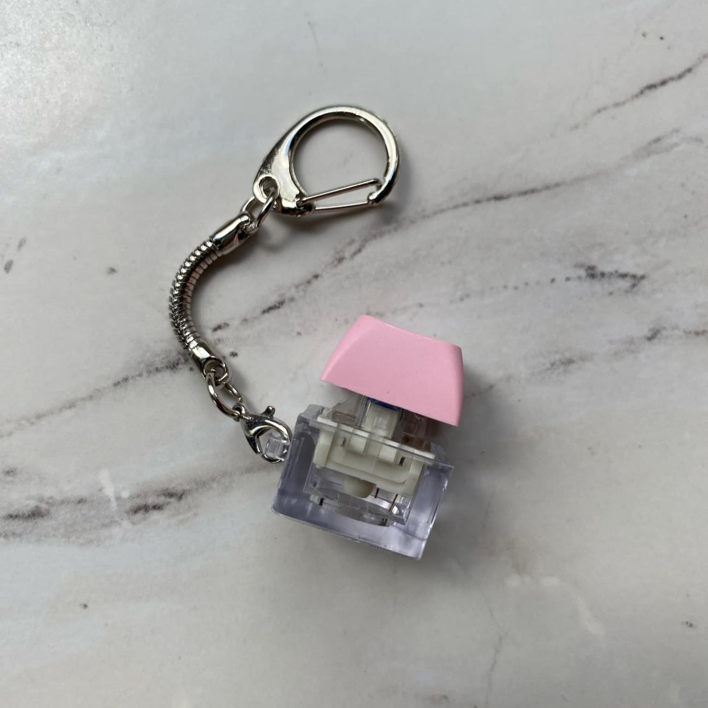 Sideview of Clicky Keychain Keyboard Fidget in Pink