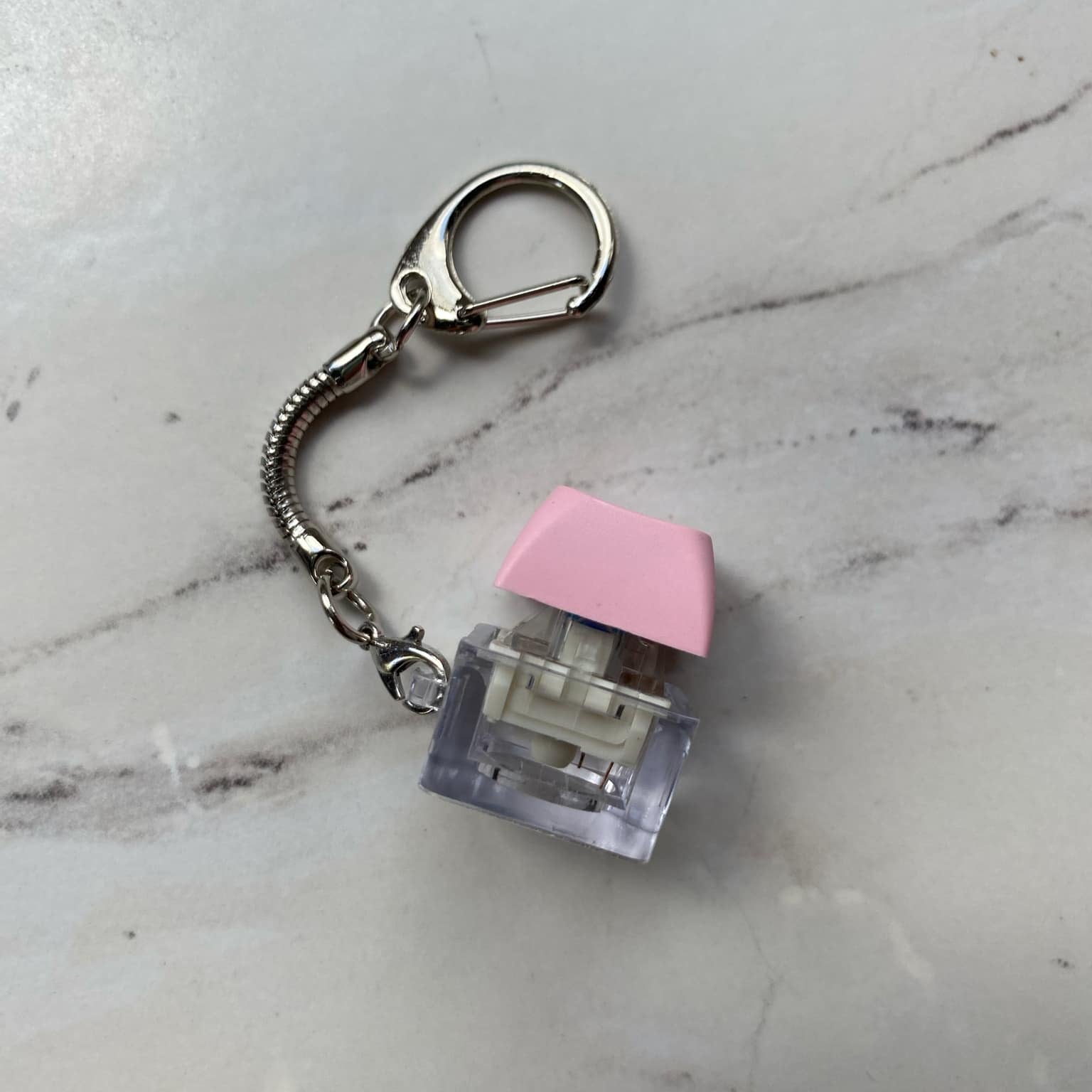 Sideview of Clicky Keychain Keyboard Fidget in Pink