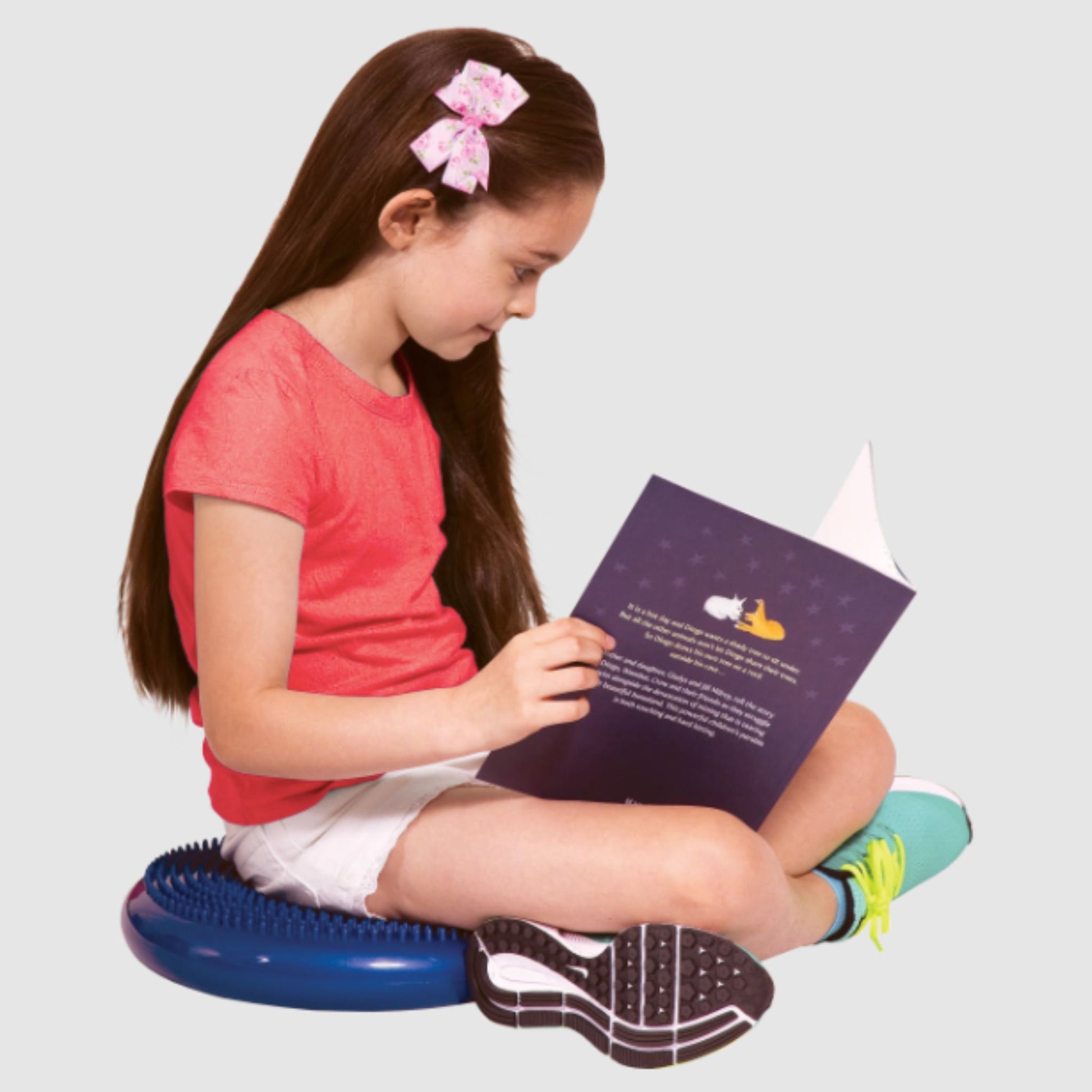 Girl sitting on Elizabeth Richards Tactile Cushion in blue