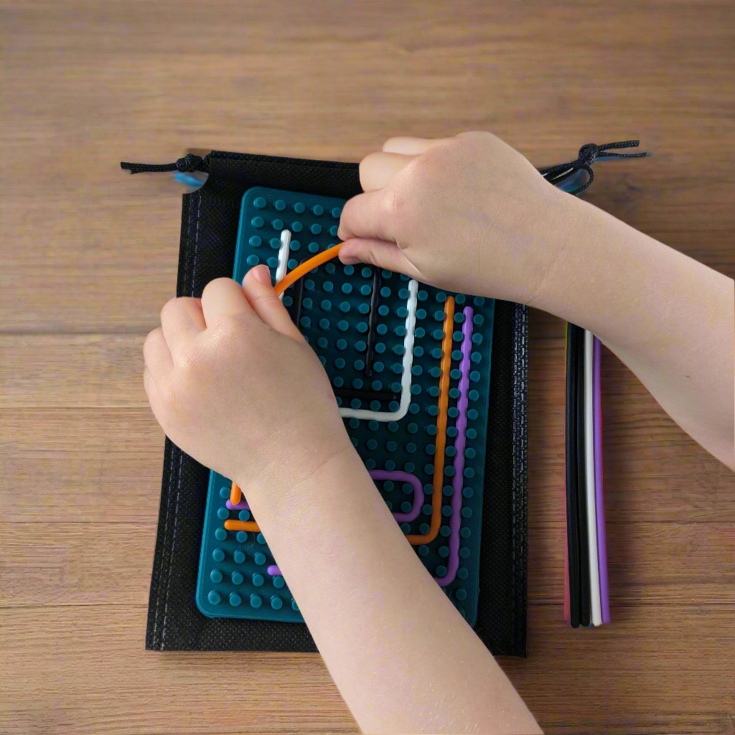 Child playing with green silicone Sensory Activity Board