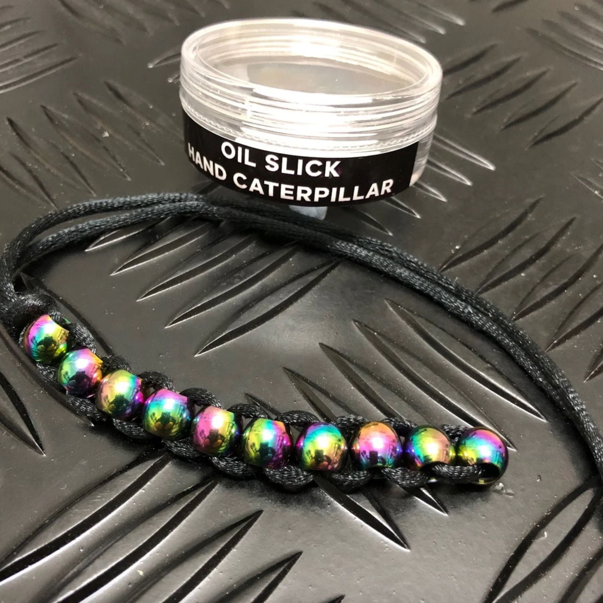 Hand Caterpillar Fidget by Kaiko in Oil Slick with Container