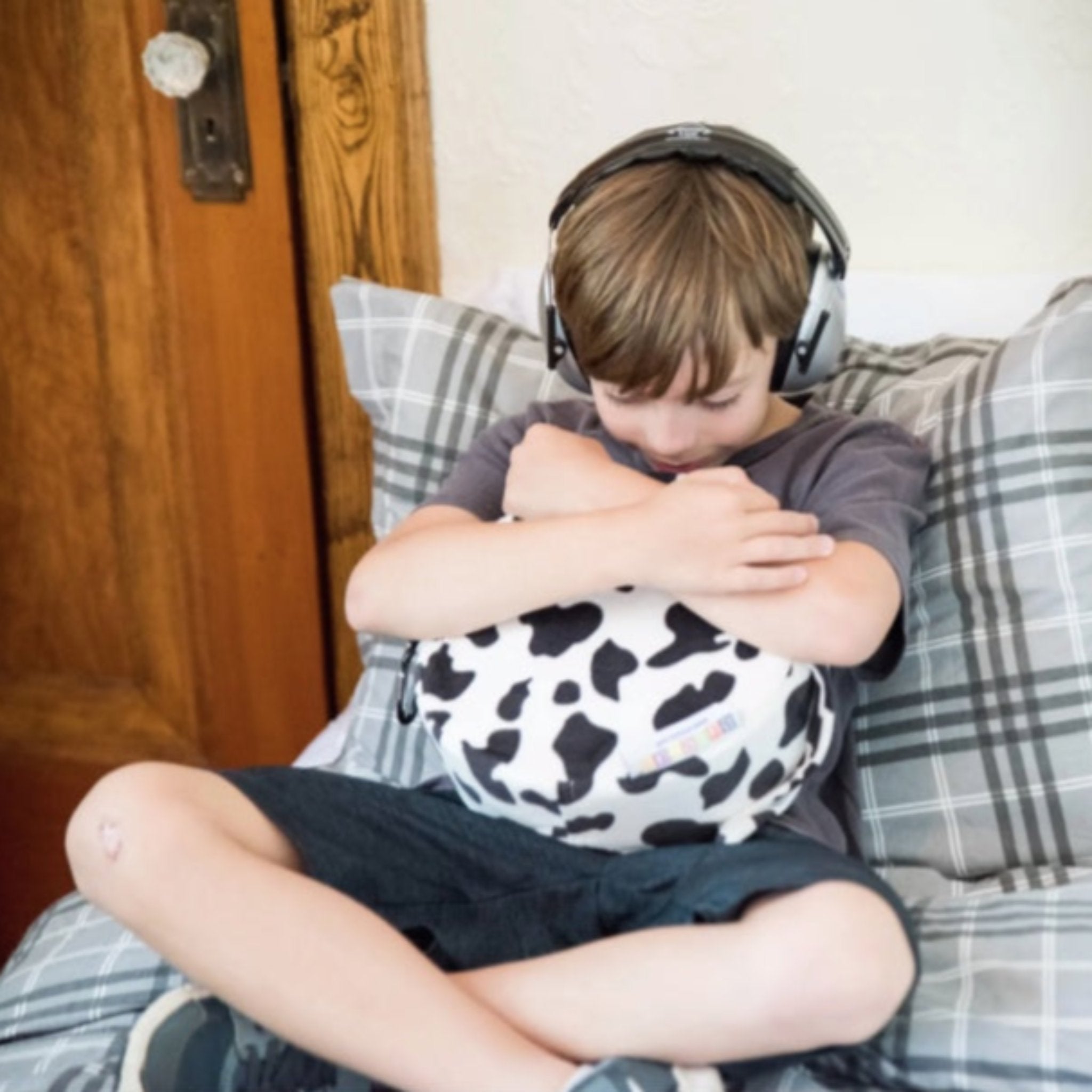 Child using the Senseez Vibrating Cushion, Touchables in the Furry Cow design